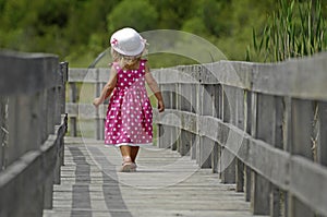 Little blond girl on boardwalk