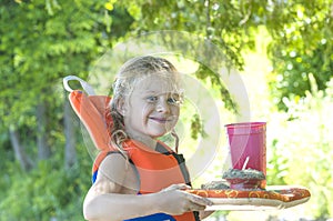 Little blond girl with handmade beach lunch