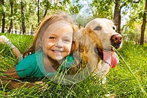 Little blond girl with her retriever dog