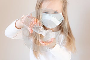 Little blond girl with a medical mask on her face