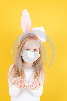 Little blond girl with a medical mask on her face