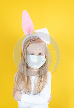 Little blond girl with a medical mask on her face