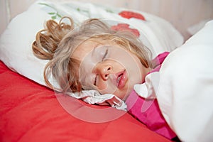 Little blond girl is sleeping