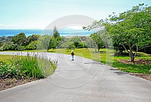 Little blond girl is strolling along Aurora Lodge garden in Waipu