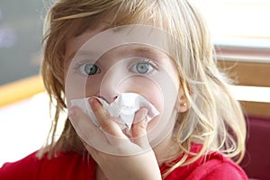 Little blond girl tissue in nose