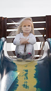 Little blond girl on toboggan