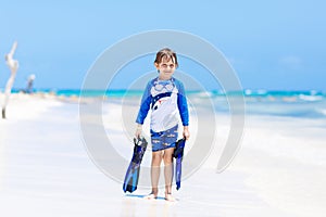 Little blond kid boy having fun on tropical beach of Haiti