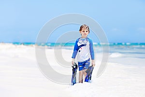 Little blond kid boy having fun on tropical beach of Mexico