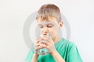 Little blonde boy drinking fresh mineral water