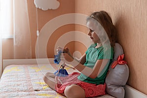 Little blonde girl playing in bedroom