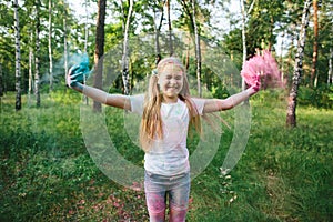 Little blonde girl playing with dry paint and smiles