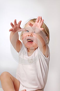 Little blonde girl in white T-shirt during play