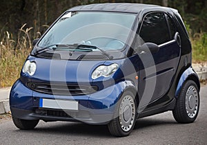 Little blue car driving on the road,  modern city car background