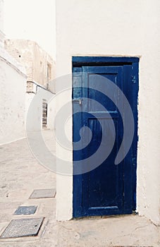 Little blue door in old street in Spain