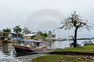 Little boat waiting on pier in Brazil on a rainy day