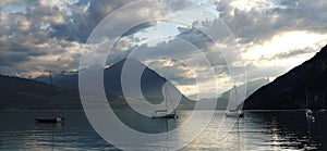 little boats on thunersee during sunset