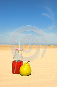 Bottle lemonade and fruit at beach