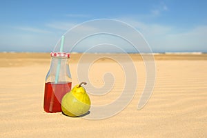 Bottle lemonade and fruit at beach