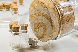 Empty little bottles with cork stopper isolated on white. big bottle with cork. transparent containers