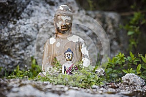 Little bouddha in wild garden photo