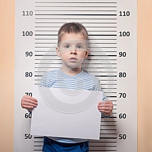 Little boy against police line-up