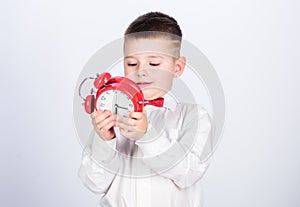 Little boy with alarm clock. Time to relax. tuxedo kid. Happy childhood. Party time. Businessman. Formal wear. happy