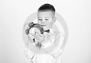 Little boy with alarm clock. Time to relax. tuxedo kid. Happy childhood. Party time. Businessman. Formal wear. happy