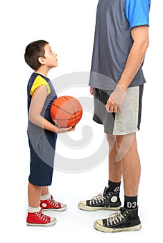 Little boy asking big man to play basketball