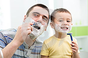 Little boy attempting to shave like his dad