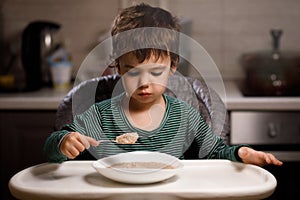 Little boy with autism eats porridge