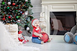 Little boy baby holding a big Christmas tree toy