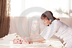 The little boy baby mother doing massage hands and legs