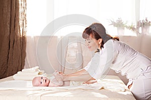 The little boy baby mother doing massage hands and legs