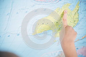 Little boy on the background of a world map