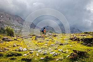 little boy with a backpack in the picturesque mountains. Traveler man with backpack, hiking, travel, lifestyle concept, mountains
