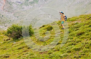 little boy with a backpack in the picturesque mountains. Traveler man with backpack, hiking, travel, lifestyle concept, mountains