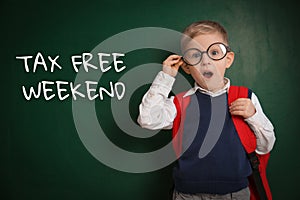 Boy with backpack and text TAX FREE WEEKEND written on chalkboard