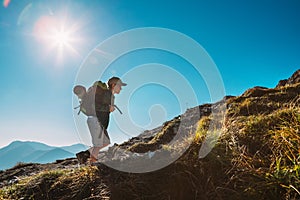 Little Boy backpacker traveler walk up on mountain top