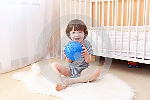 Little boy with ball indoors