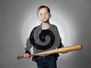 Little boy with baseball bat.Funny child in leather coat.thug