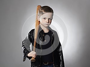 Little boy with baseball bat.Funny child in leather coat.thug