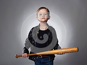 Little boy with baseball bat.Funny child in leather coat.thug