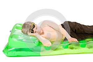Little boy on beach mattress