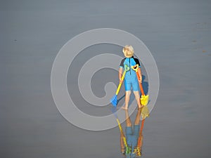 Little boy at beach standing tall