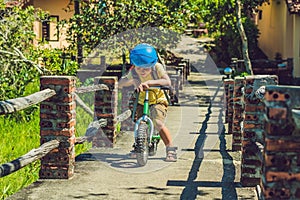 Little boy on a bicycle. Caught in motion, on a driveway motion blurred. Preschool child`s first day on the bike. The