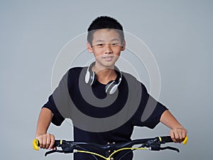 Little boy with bicycle on light background