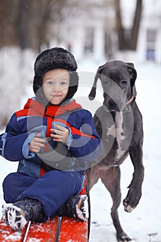 Little boy with big black dog