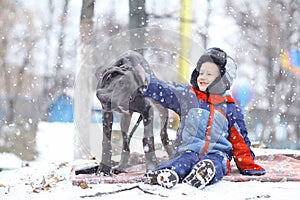 Little boy with big black dog