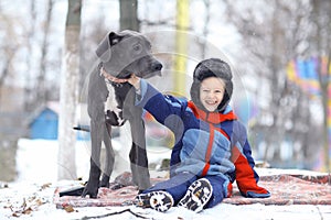 Little boy with big black dog