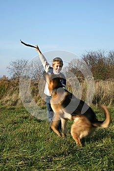 Little boy and big dog (German Shepherd ).